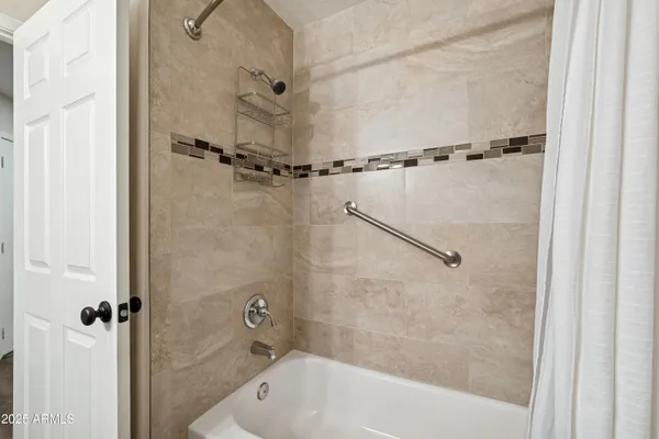 a bathroom with a bathtub and shower