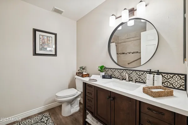 a bathroom with a toilet a sink and a mirror