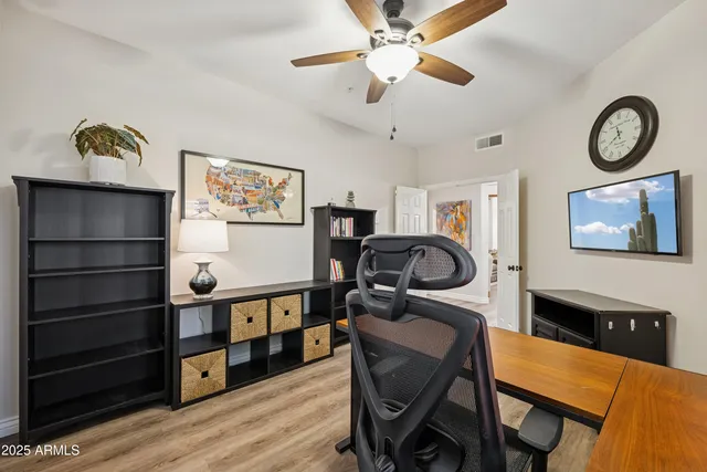 a view of a workspace with furniture and wooden floor
