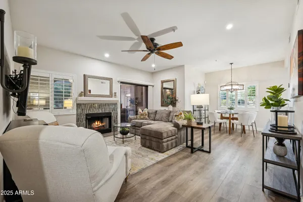 a living room with furniture a fireplace and a potted plant