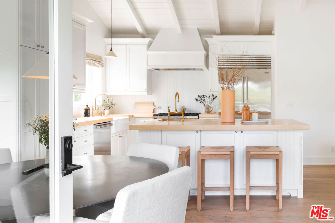 6456 Sycamore Meadows Drive Malibu, CA 90265 - Photo 11 of 29 a kitchen with white cabinets and sink