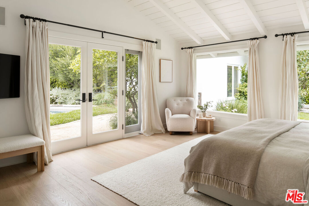 6456 Sycamore Meadows Drive Malibu, CA 90265 - Photo 15 of 29 a spacious bedroom with a bed and a large window