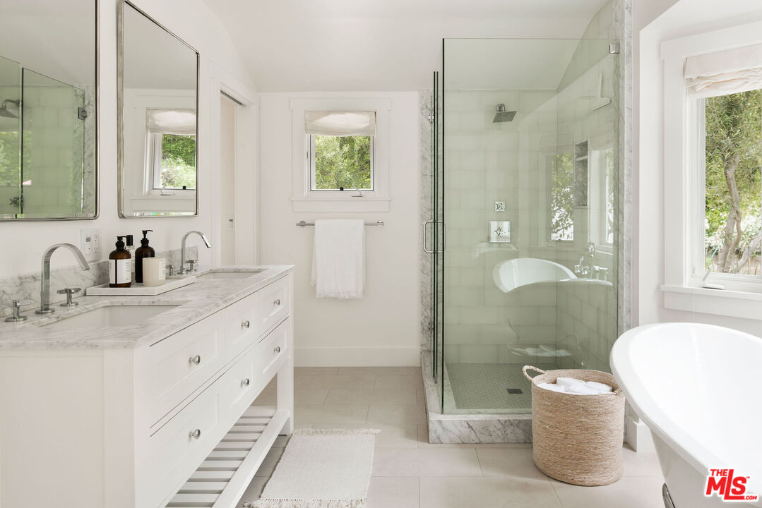 6456 Sycamore Meadows Drive Malibu, CA 90265 - Photo 17 of 29 a bathroom with a double vanity sink toilet and shower