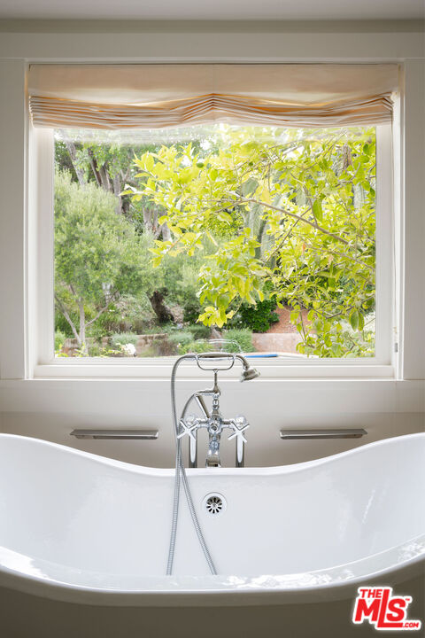 6456 Sycamore Meadows Drive Malibu, CA 90265 - Photo 18 of 29 a white bath tub sitting in a bathroom next to a window