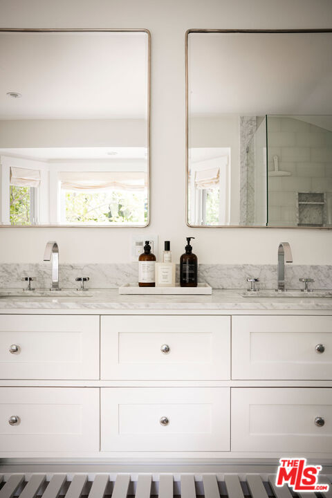 6456 Sycamore Meadows Drive Malibu, CA 90265 - Photo 19 of 29 a bathroom with a sink and a mirror