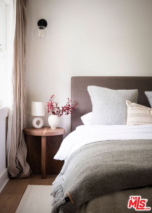 6456 Sycamore Meadows Drive Malibu, CA 90265 - Photo 20 of 29 a bedroom with a bed and a potted plant