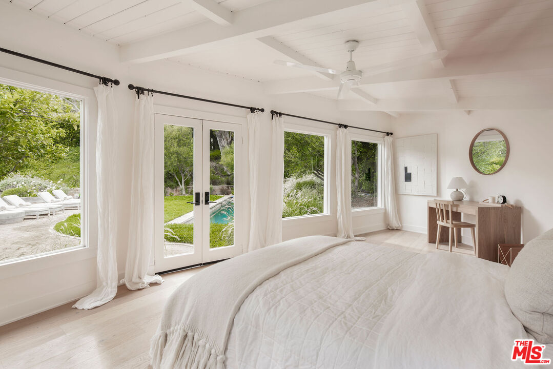 6456 Sycamore Meadows Drive Malibu, CA 90265 - Photo 25 of 29 a bedroom with a large bed and a large window