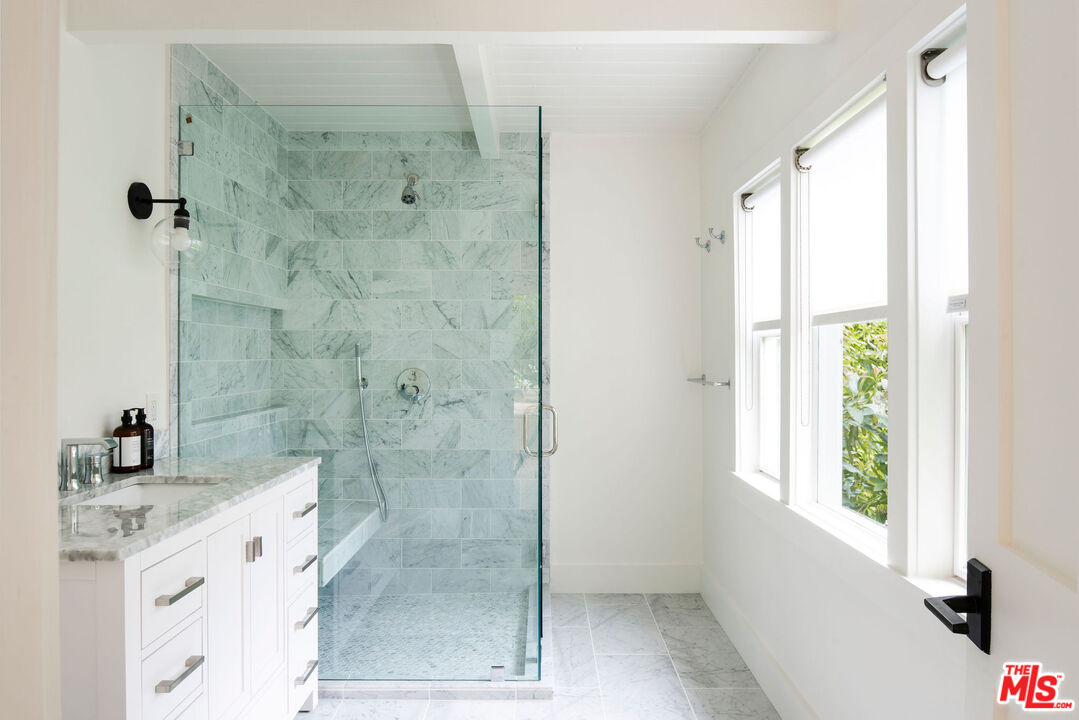6456 Sycamore Meadows Drive Malibu, CA 90265 - Photo 28 of 29 a bathroom with a shower sink and mirror