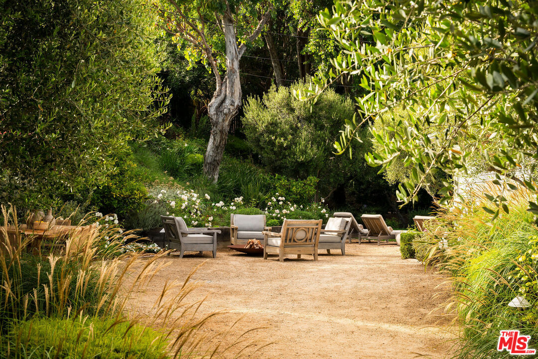 6456 Sycamore Meadows Drive Malibu, CA 90265 - Photo 3 of 29 a backyard of a house with table and chairs