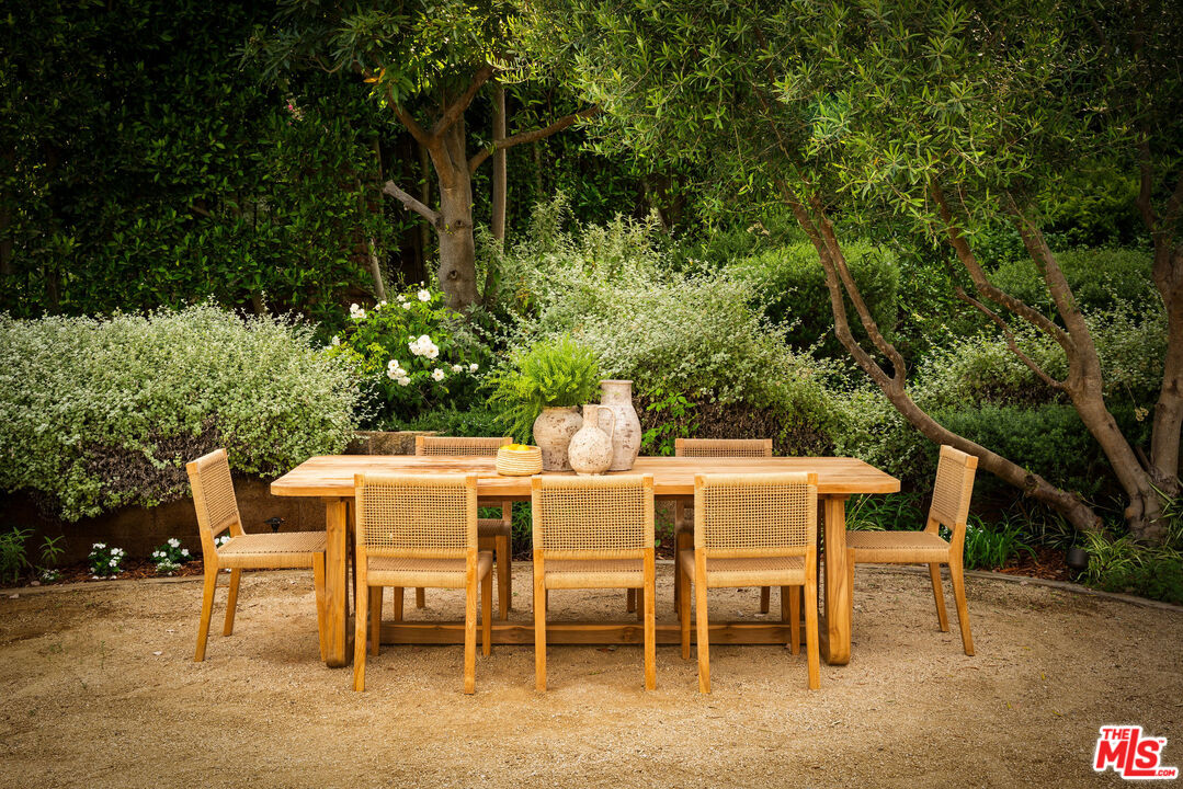 6456 Sycamore Meadows Drive Malibu, CA 90265 - Photo 4 of 29 a view of a dining table and chairs in the patio