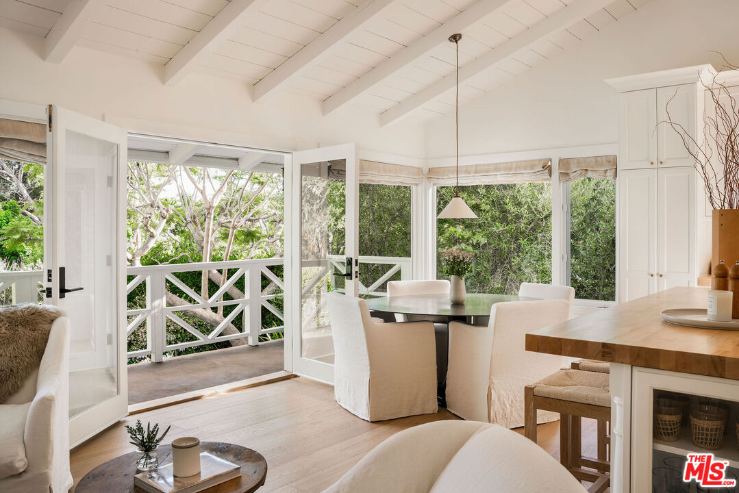 6456 Sycamore Meadows Drive Malibu, CA 90265 - Photo 9 of 29 a room with furniture a large window and a chandelier