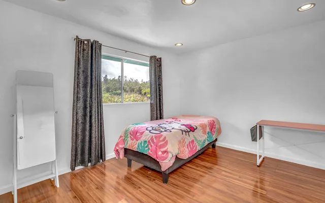 a bedroom with a bed and a window