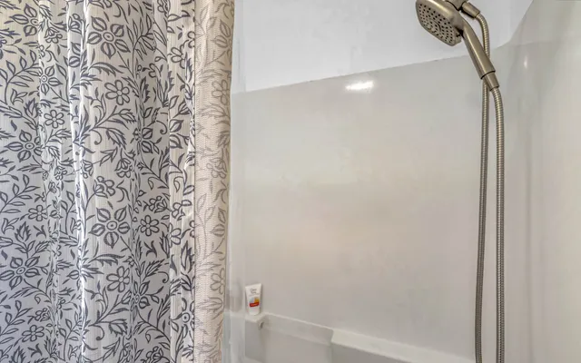 a bathroom with a shower curtain and a shower curtain