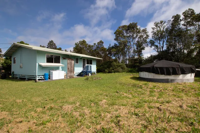 a front view of house with yard and swimming pool