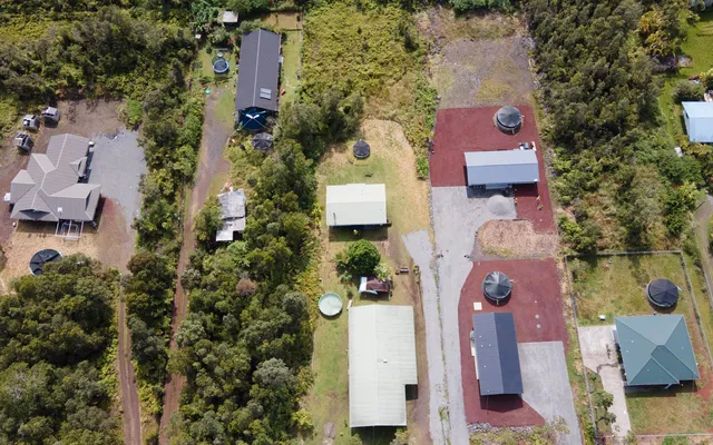 an aerial view of residential houses with outdoor space and street view