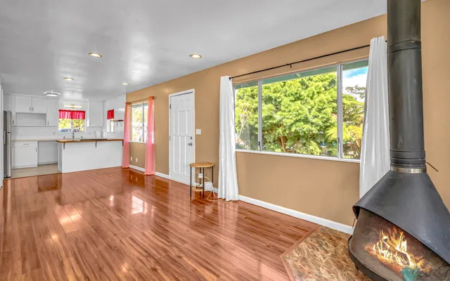 a view of kitchen and hall with wooden floor