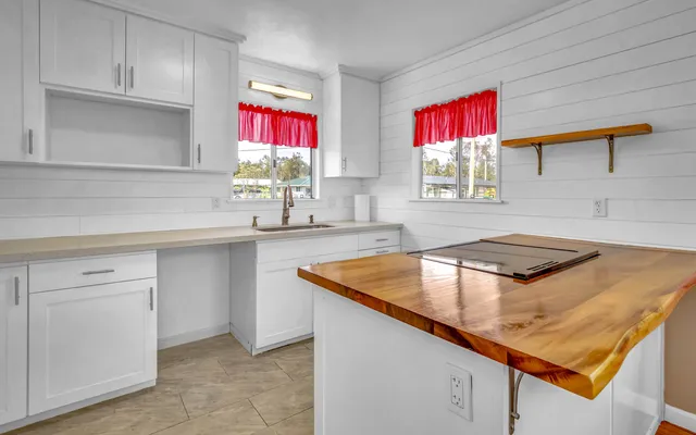 a kitchen with stainless steel appliances granite countertop a sink a stove and a microwave