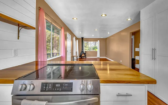 a view of a kitchen with a sink and large window