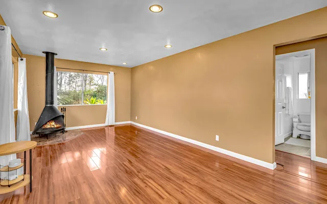 a view of a room with wooden floor and windows