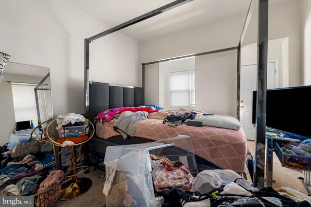 a bedroom with bed and a tv