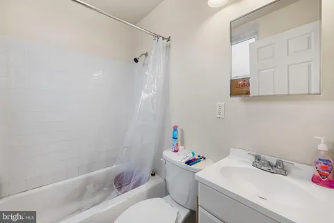 a bathroom with a sink toilet and a bathtub