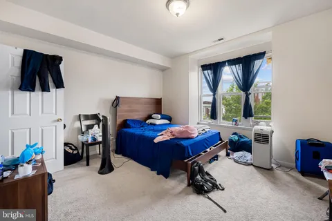 a bed room with furniture and a window