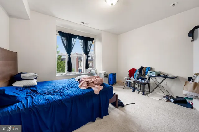 a bedroom with furniture and a large window