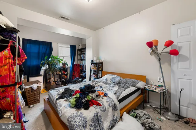 a bed room with a bed and a chandelier