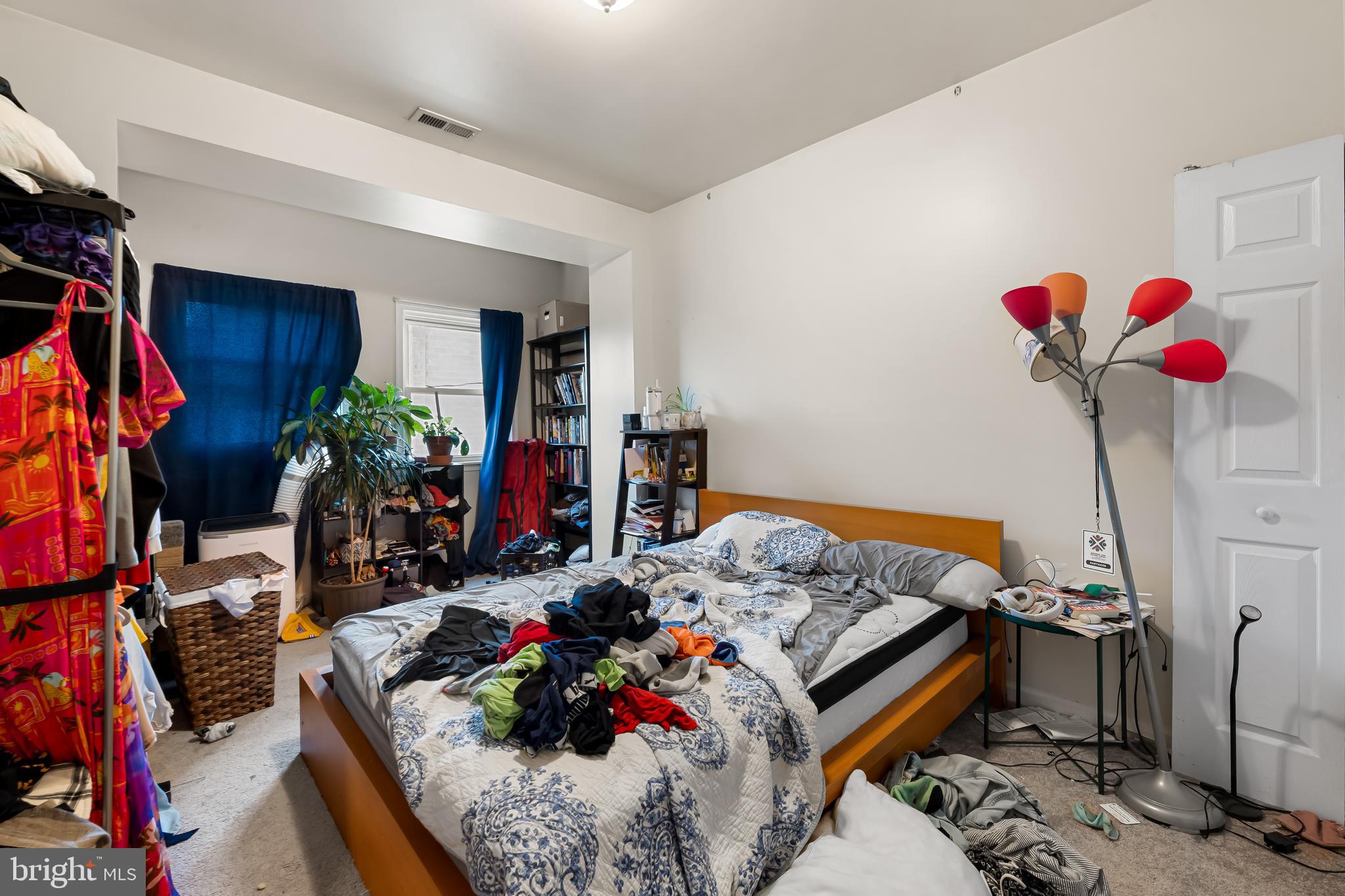 906 Whitelock Street Baltimore, MD 21217 - Photo 21 of 36 a bed room with a bed and a chandelier