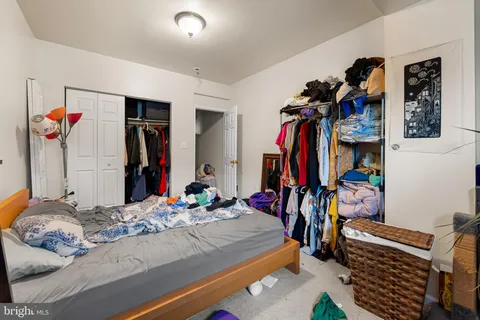 a bed room with a bed and a walk in closet