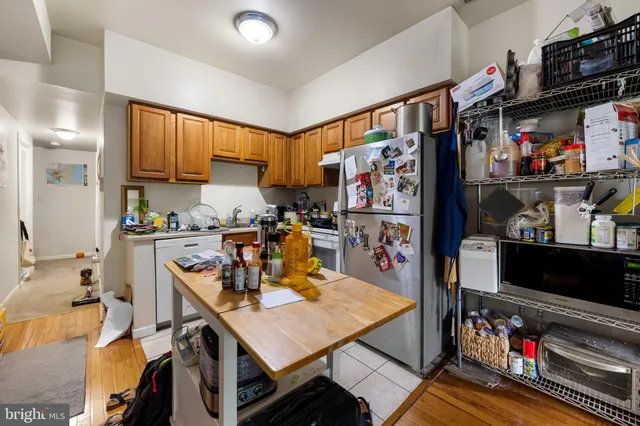 a view of a kitchen with fridge and a window