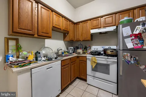a kitchen with stainless steel appliances granite countertop a sink dishwasher stove and cabinets