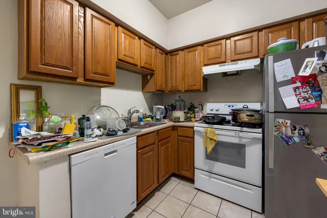 a kitchen with stainless steel appliances granite countertop a sink dishwasher stove and cabinets