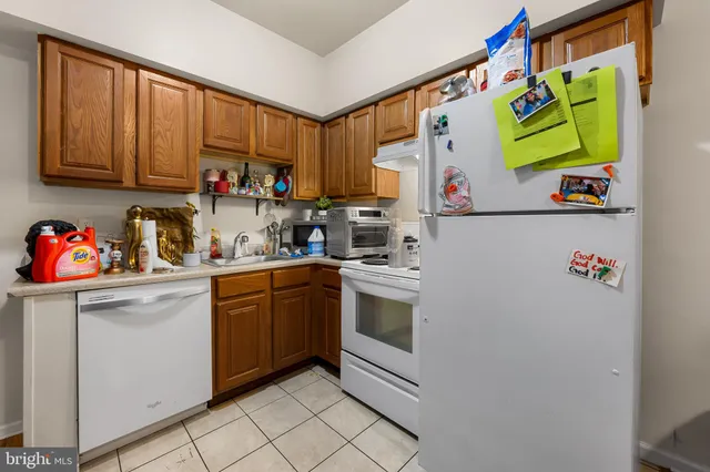a kitchen with stainless steel appliances granite countertop a sink and a refrigerator