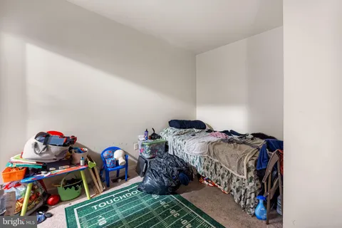 a bedroom with two beds and a couch