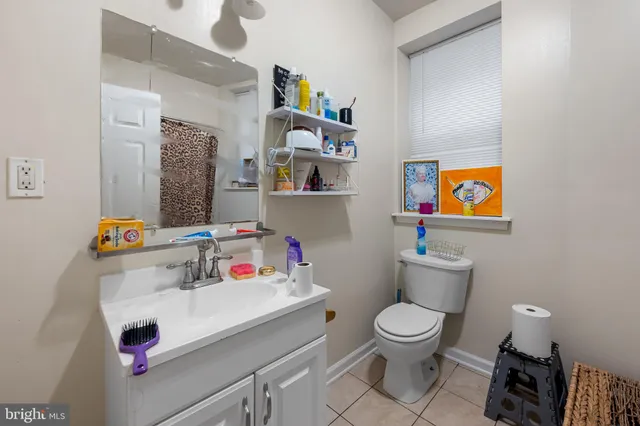 a bathroom with a sink mirror vanity and toilet