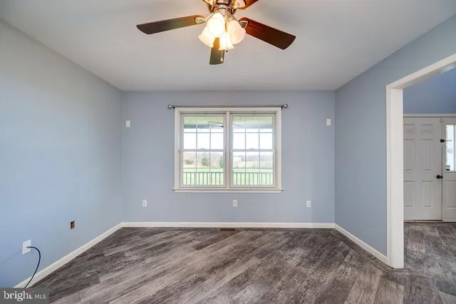 wooden floor in an empty room with a window