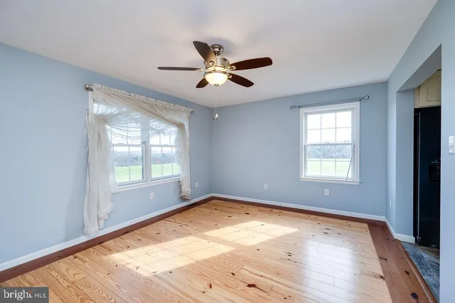 wooden floor in an empty room with a window