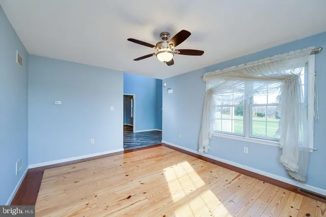 a view of an empty room with a fireplace