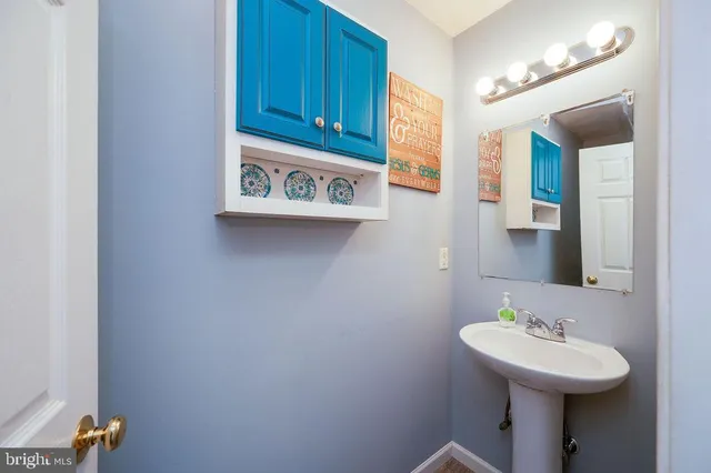 a view of a house with a yard and a large tree