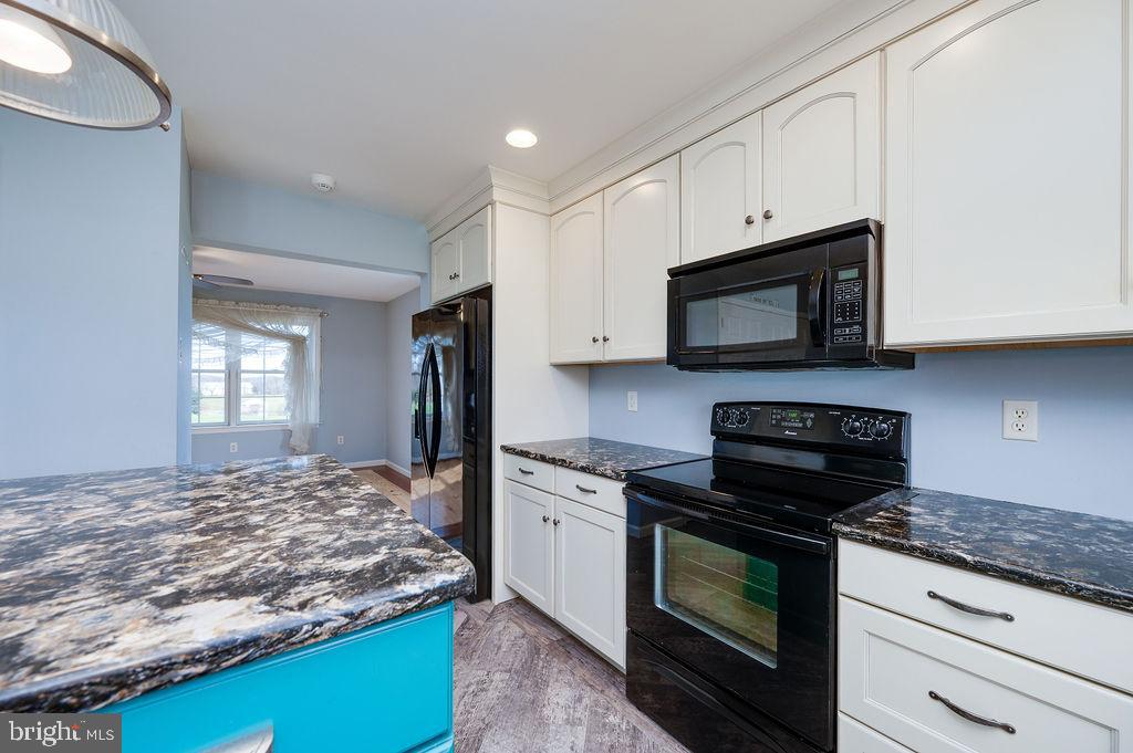 130 Troxel Road Shoemakersville, PA 19555 - Photo 25 of 100 a kitchen with kitchen island granite countertop stainless steel appliances a stove microwave and sink