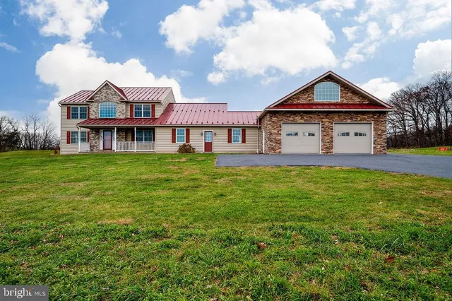 a kitchen with kitchen island granite countertop stainless steel appliances a stove microwave and sink