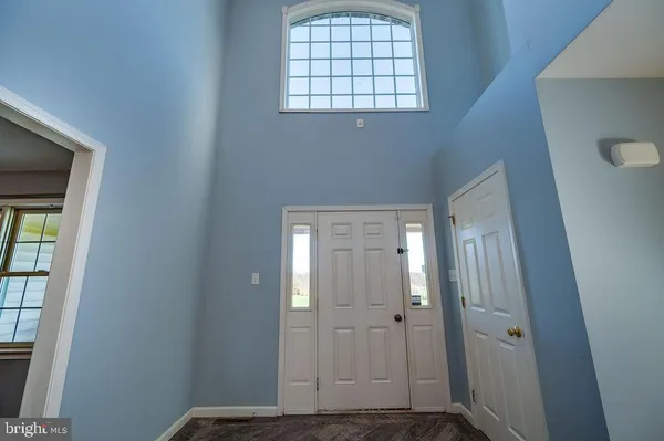 a view of empty room with wooden floor and ceiling fan
