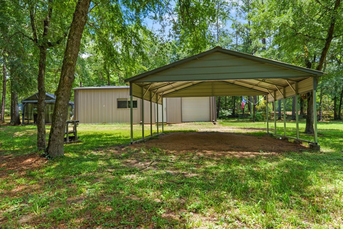 16375 Grand Flower Road Plantersville, TX 77363 - Photo 17 of 50 a backyard of a house with lots of green space