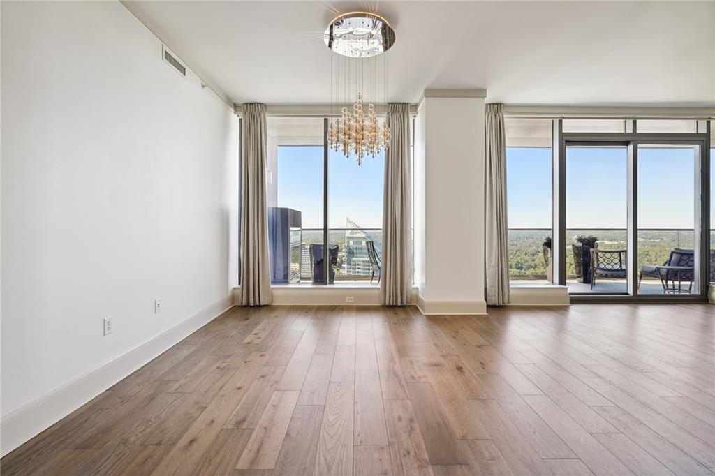 3344 Peachtree Road Northeast, Unit 3202 Atlanta, GA 30326 - Photo 12 of 39 a view of a room with wooden floor and a large window