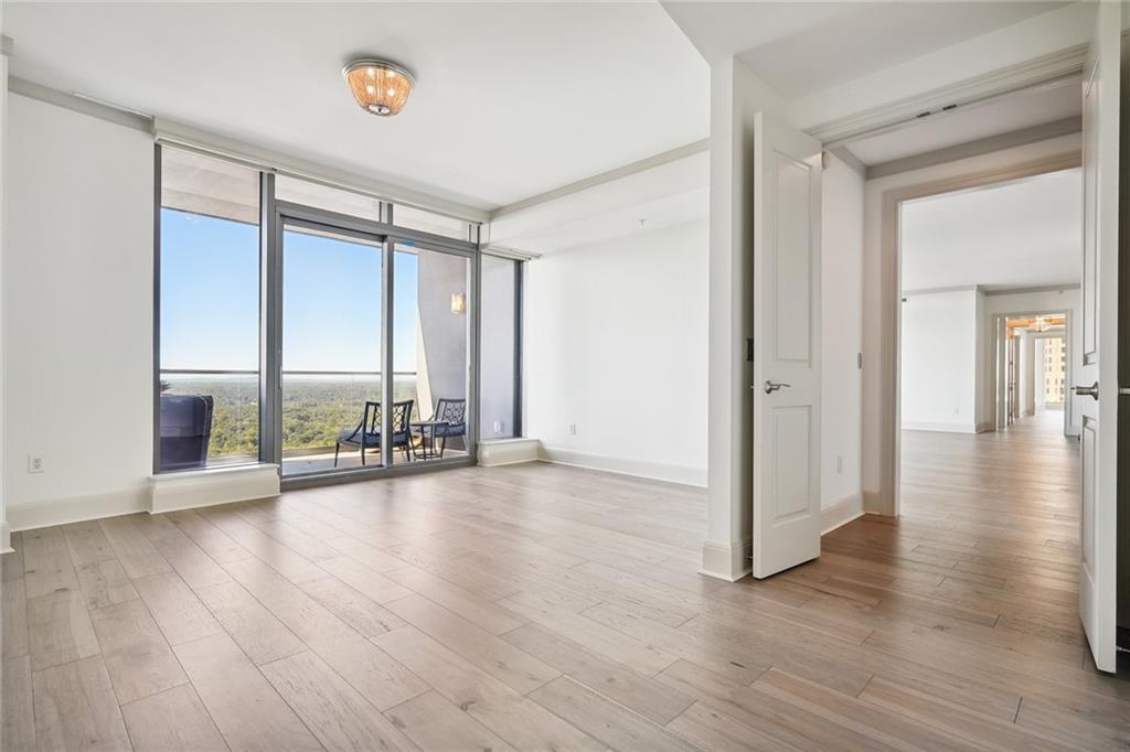 3344 Peachtree Road Northeast, Unit 3202 Atlanta, GA 30326 - Photo 18 of 39 wooden floor in an empty room with a window