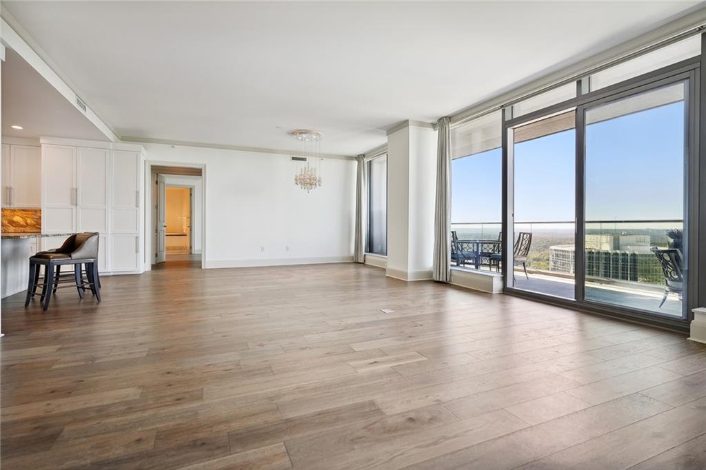 3344 Peachtree Road Northeast, Unit 3202 Atlanta, GA 30326 - Photo 2 of 39 a view of an empty room with window and wooden floor