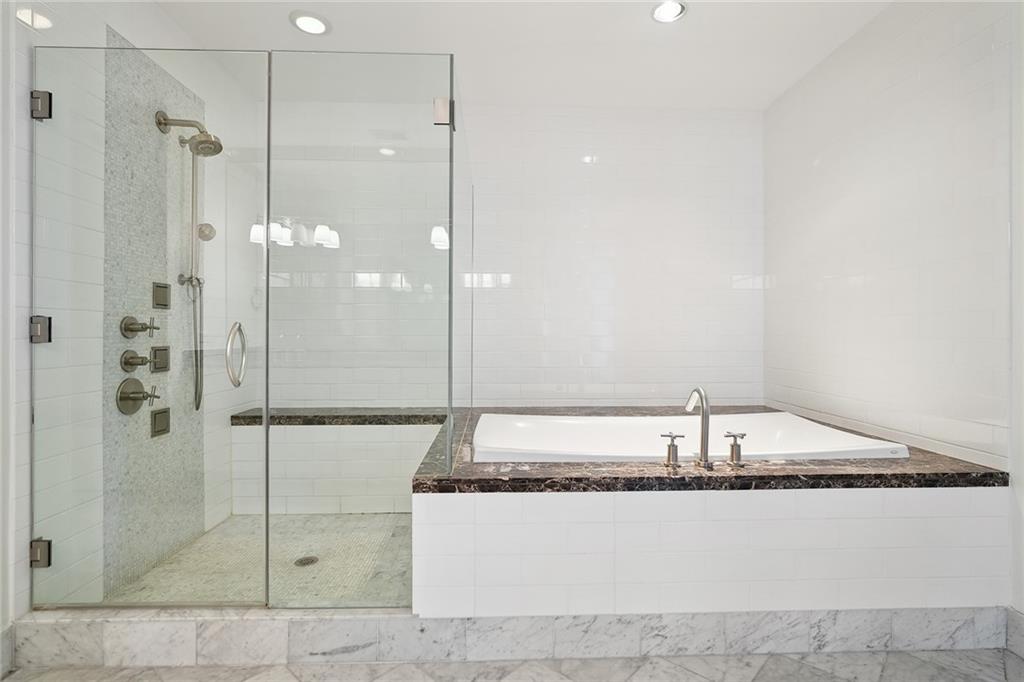 3344 Peachtree Road Northeast, Unit 3202 Atlanta, GA 30326 - Photo 21 of 39 a bathroom with a shower and a bath tub