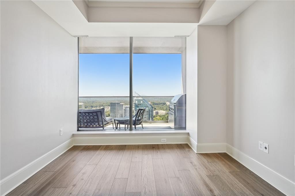 3344 Peachtree Road Northeast, Unit 3202 Atlanta, GA 30326 - Photo 24 of 39 an empty room with wooden floor and windows