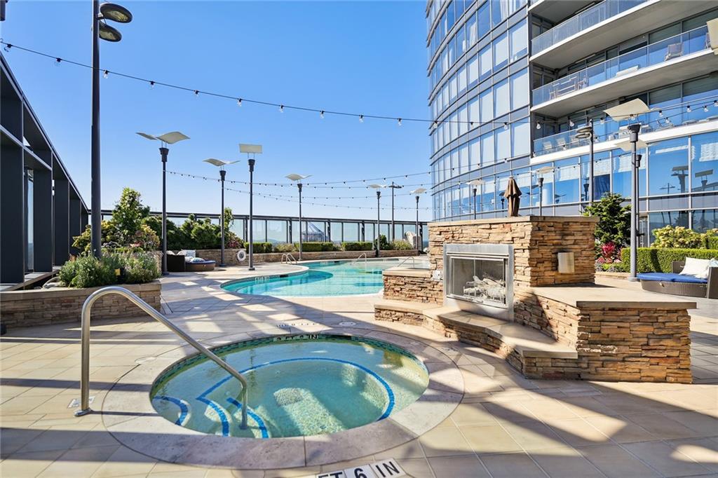 3344 Peachtree Road Northeast, Unit 3202 Atlanta, GA 30326 - Photo 32 of 39 a view of a swimming pool with a patio